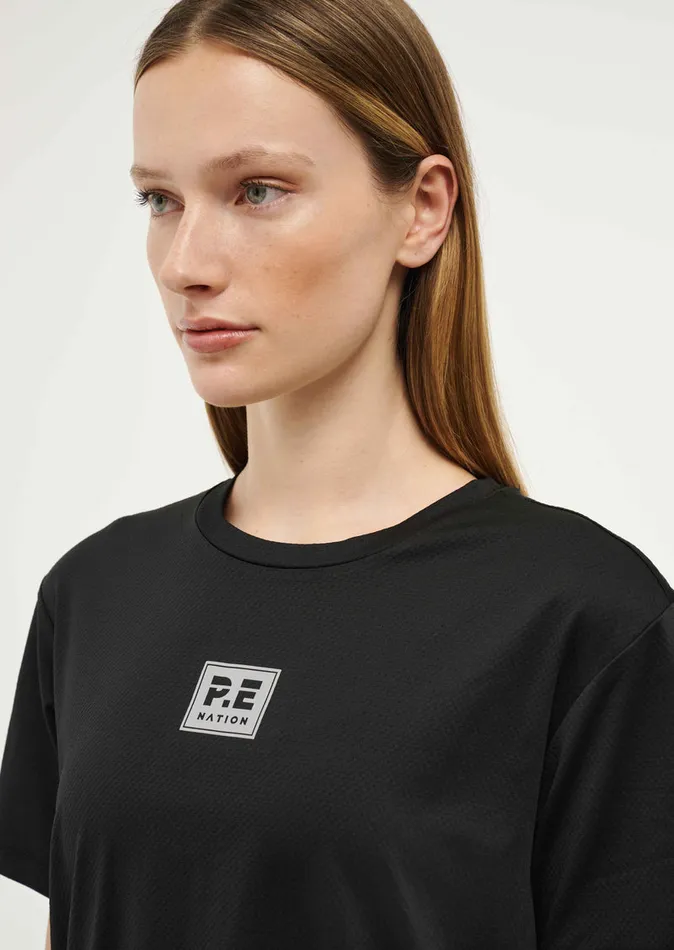 Baseline PE Nation Women CROSSOVER TEE IN BLACK