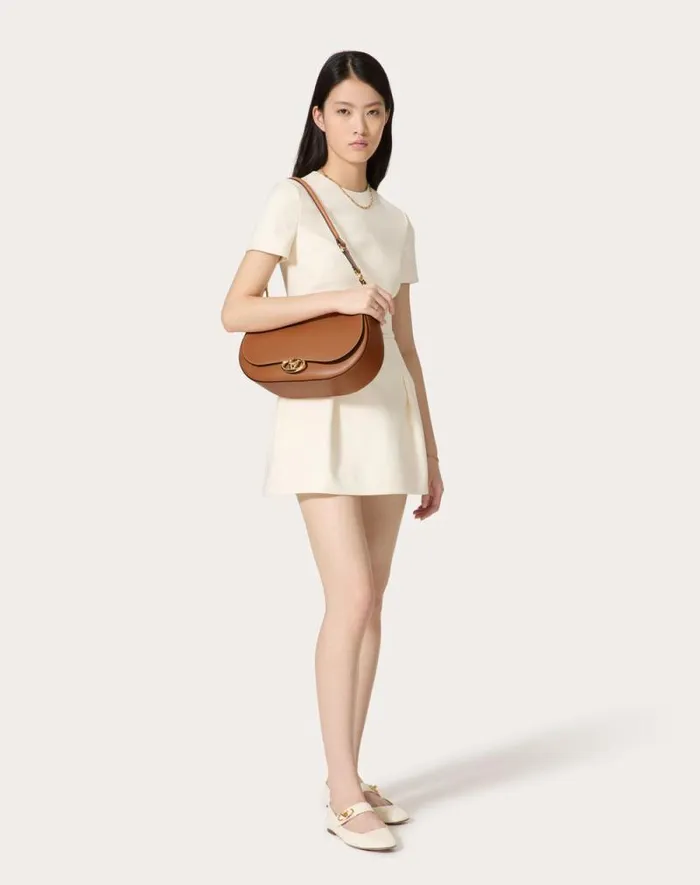 Valentino Shoulder Bags Woman Valentino Garavani Ohval Medium Shoulder Bag In Nappa Calfskin For Woman In Almond Almond Valentino Shoulder Bags Woman Valentino Garavani Ohval Medium Shoulder Bag In Nappa Calfskin For Woman In Almond Almond