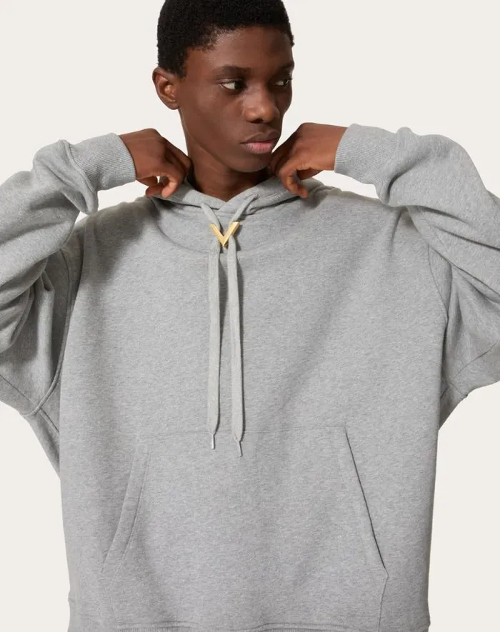 Valentino Tshirts And Sweatshirts Man Cotton Hooded Sweatshirt With Metallic V Detail For Man In Grey Grey Valentino Tshirts And Sweatshirts Man Cotton Hooded Sweatshirt With Metallic V Detail For Man In Grey Grey